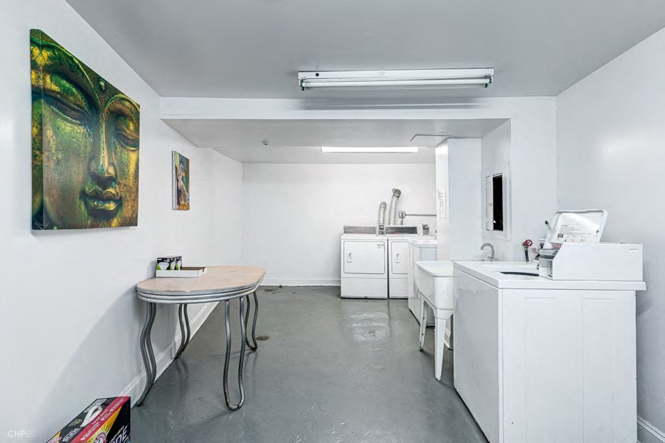 A room with a table and a painting on the wall.