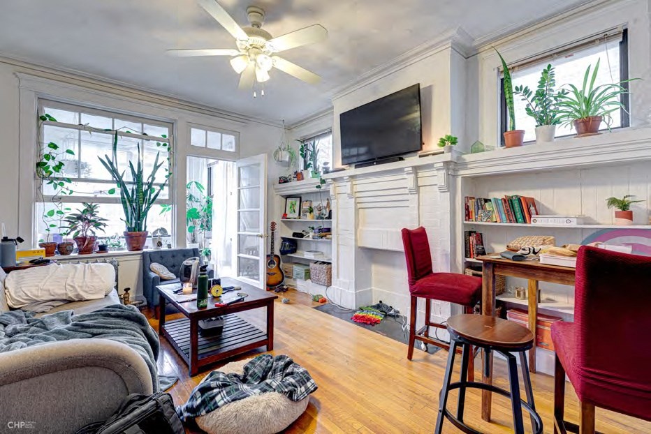 A living room with a fireplace and a television.