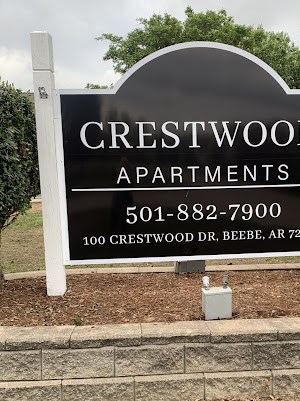 Crestwood Apartments Entry A sign for Crestwood Apartments with a phone number and address.