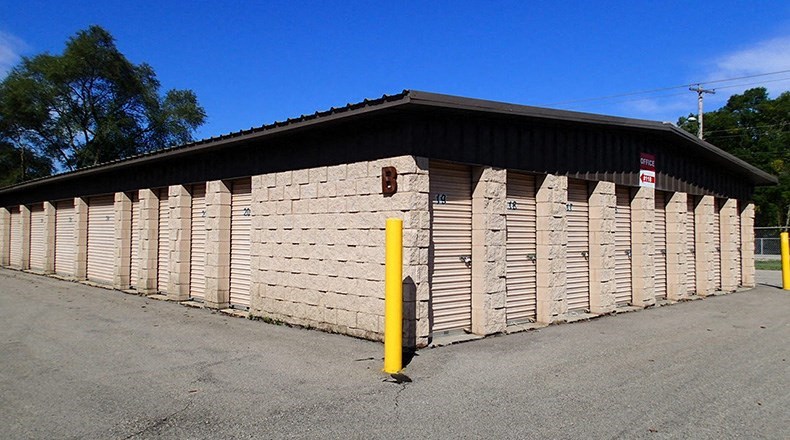 A building with a yellow post in front of it.