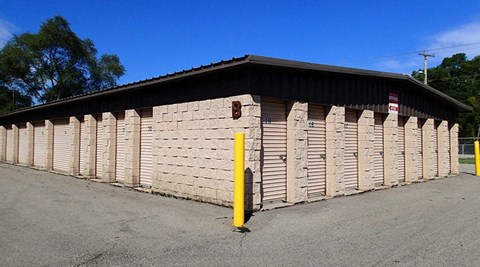 A building with a yellow post in front of it.