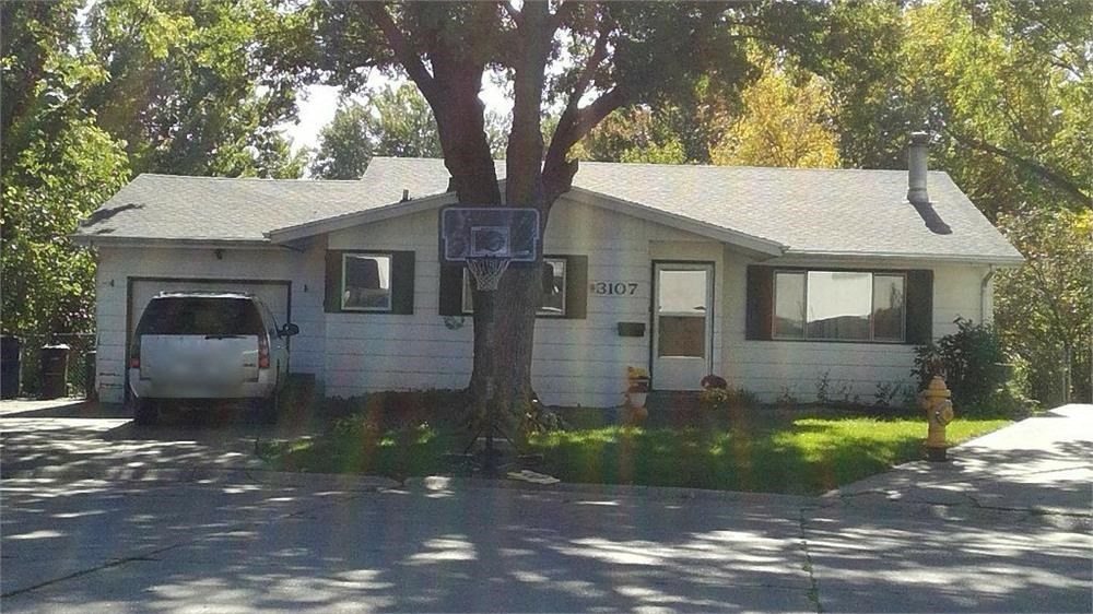a white house with a tree in front of it