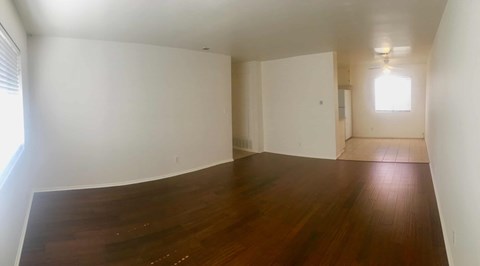 Empty room with wooden floor and white walls.