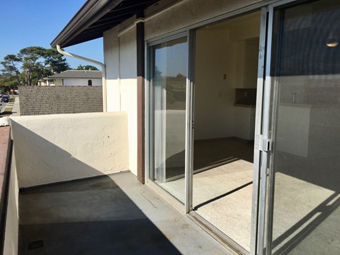 A glass door is open to a room with a tiled floor.