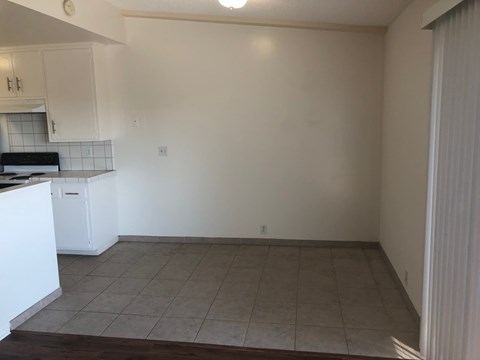 A kitchen with white cabinets and a tiled backsplash.