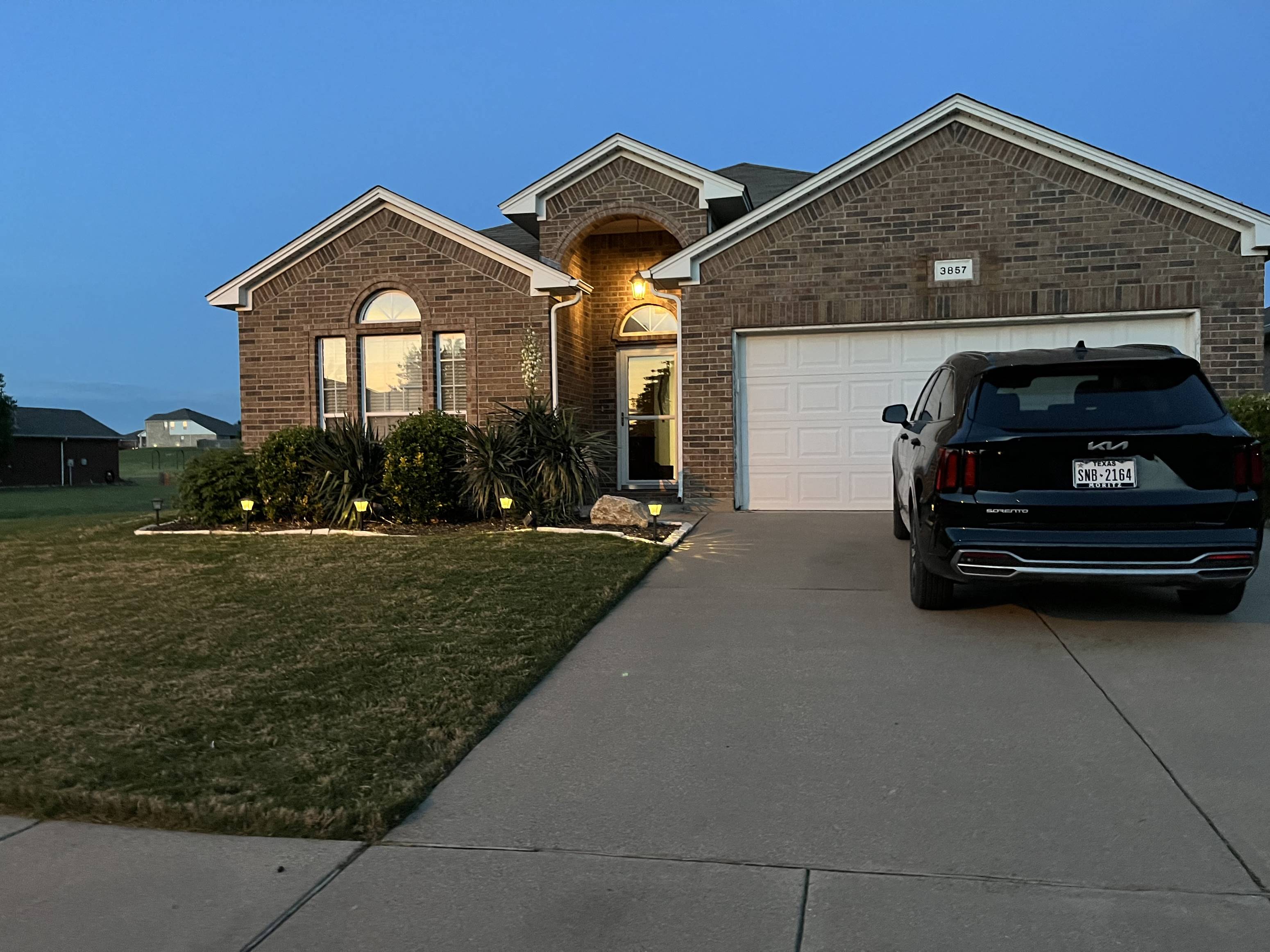 a car parked in a driveway in front of a house