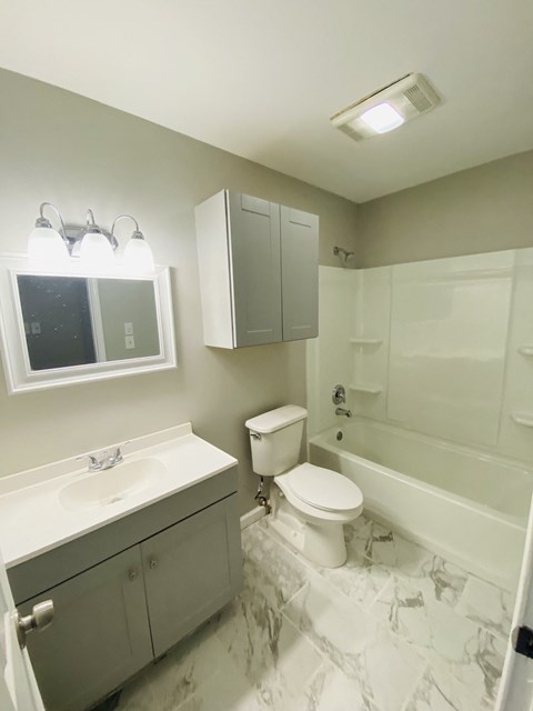 a bathroom with a sink toilet and a bath tub