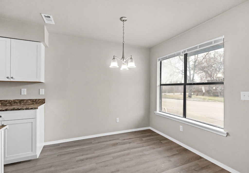 an empty kitchen and living room with a large window