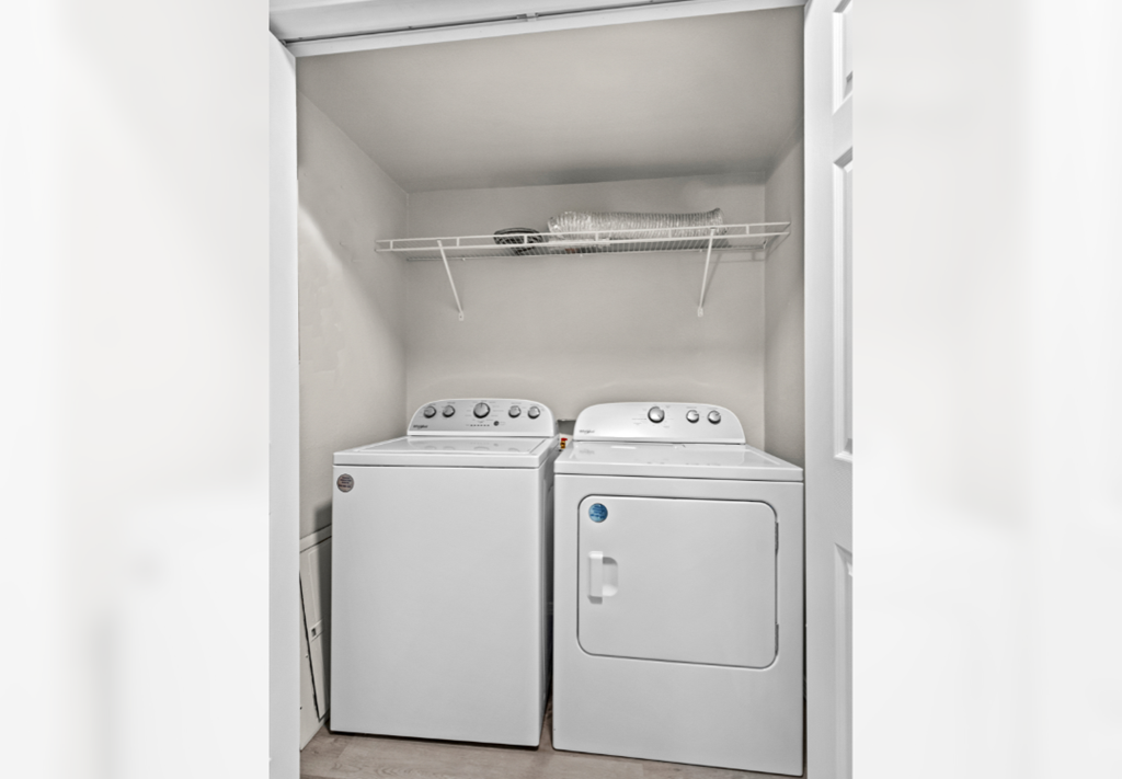 a washer and dryer in a laundry room with white appliances