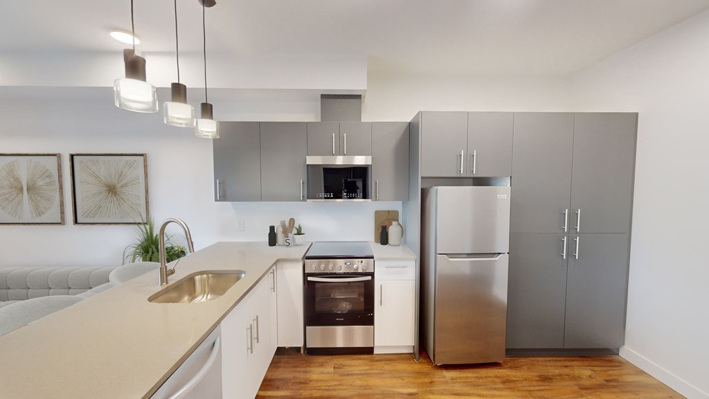 A modern kitchen with stainless steel appliances and white cabinets.