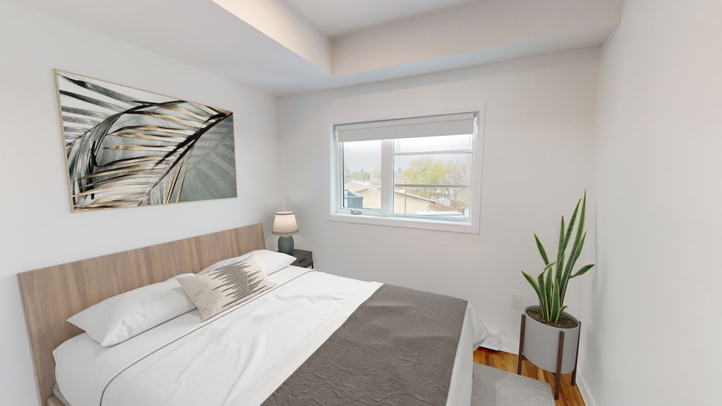 A bedroom with a bed, a lamp, a plant, and a painting on the wall.