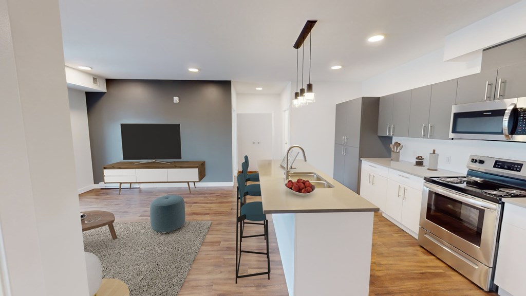 A modern kitchen with a white island and stainless steel appliances.