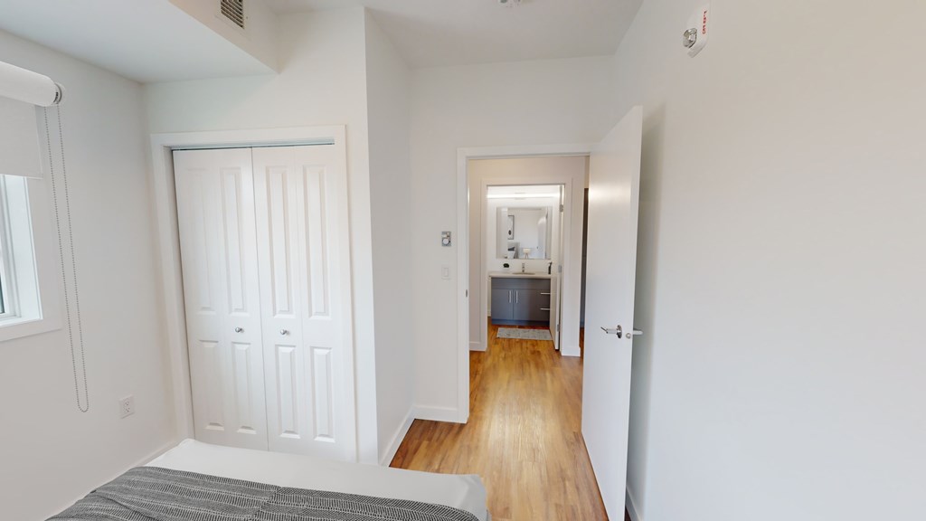 A white door is in the middle of a hallway.