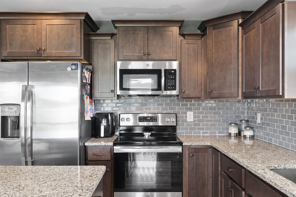 a kitchen with stainless steel appliances and granite counter tops