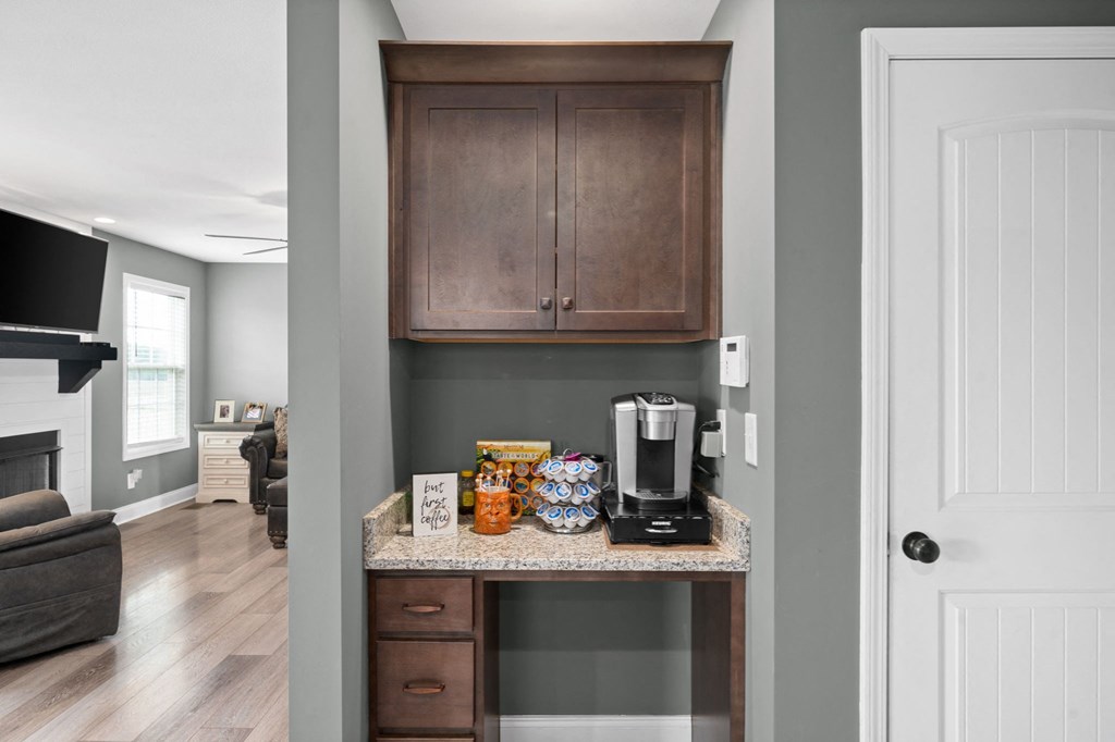 a kitchen with a coffee maker and a counter with snacks