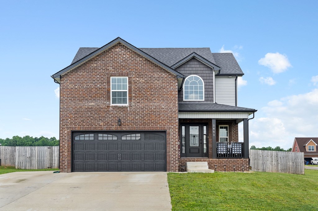 a brick house with a black garage door