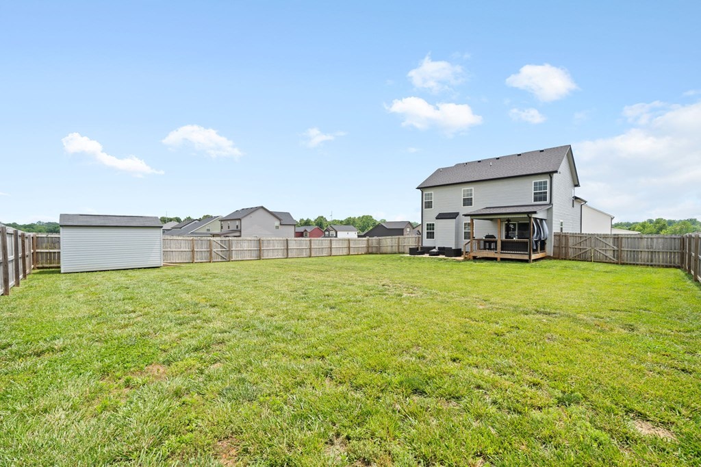 a backyard with a fence and a house