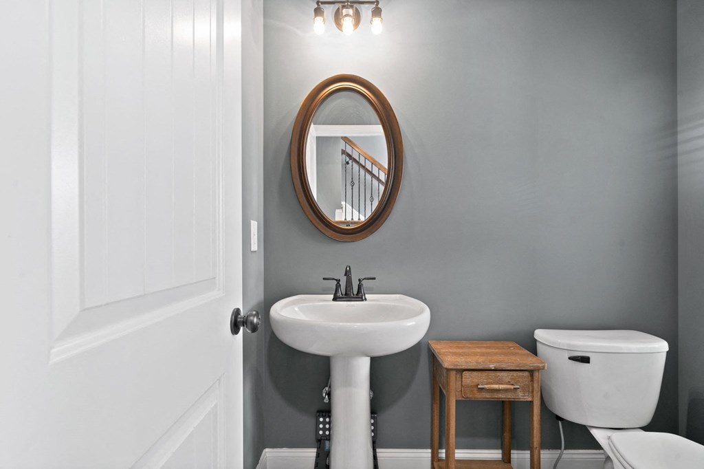 a bathroom with a sink and a mirror and a toilet