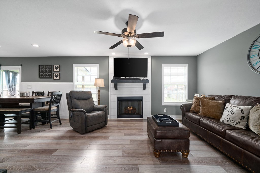 the living room has a fireplace and a tv above it