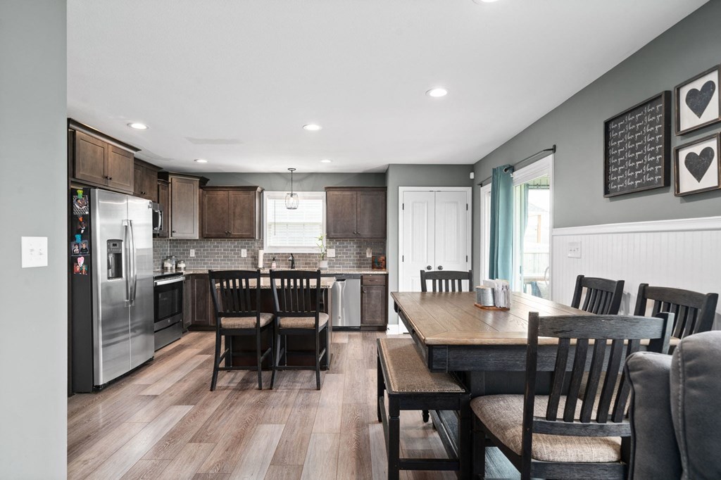 a kitchen and dining room with a wooden table and chairs