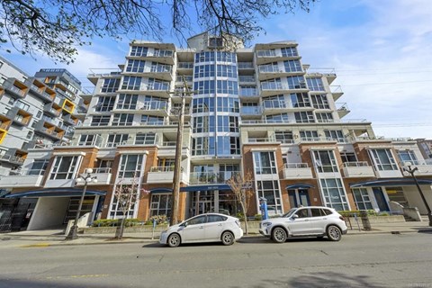 two cars parked in front of an apartment building