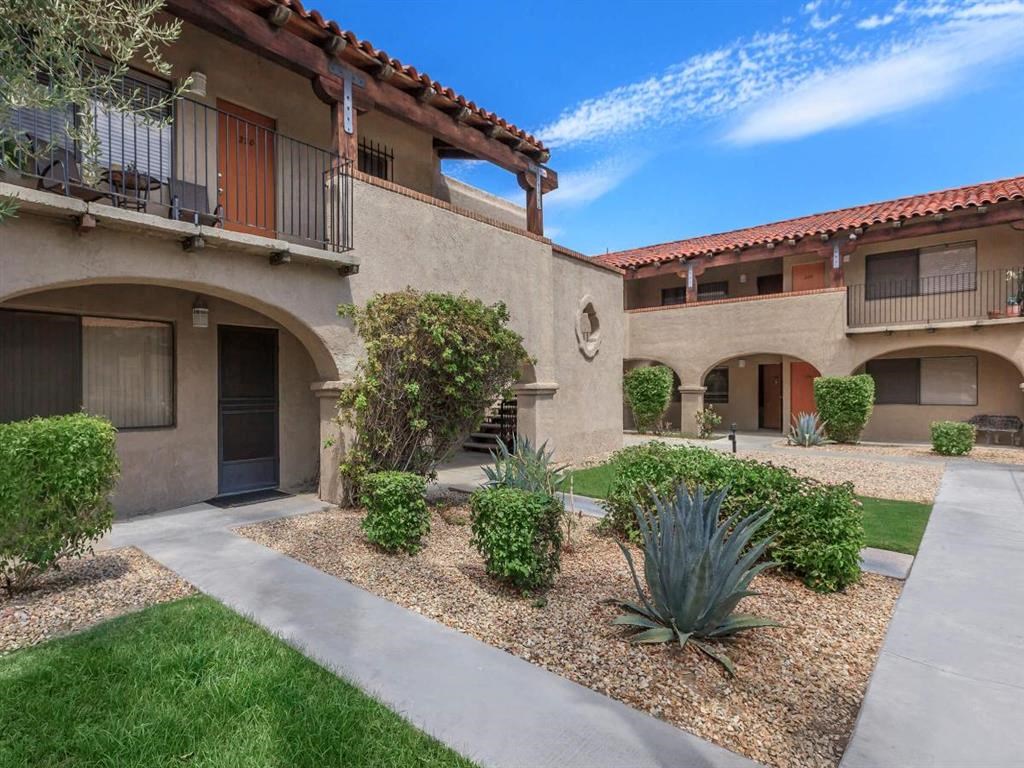 a courtyard with a building and a staircase