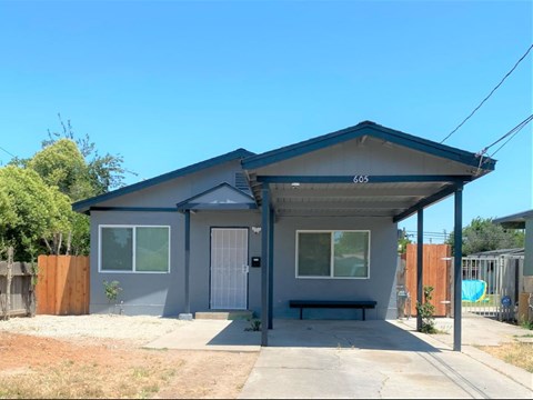 A house with a grey exterior and a covered patio area.