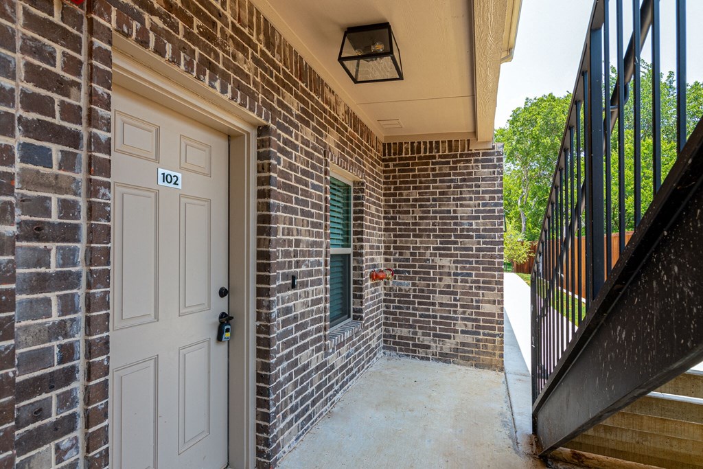 the entrance to a brick building with a white door