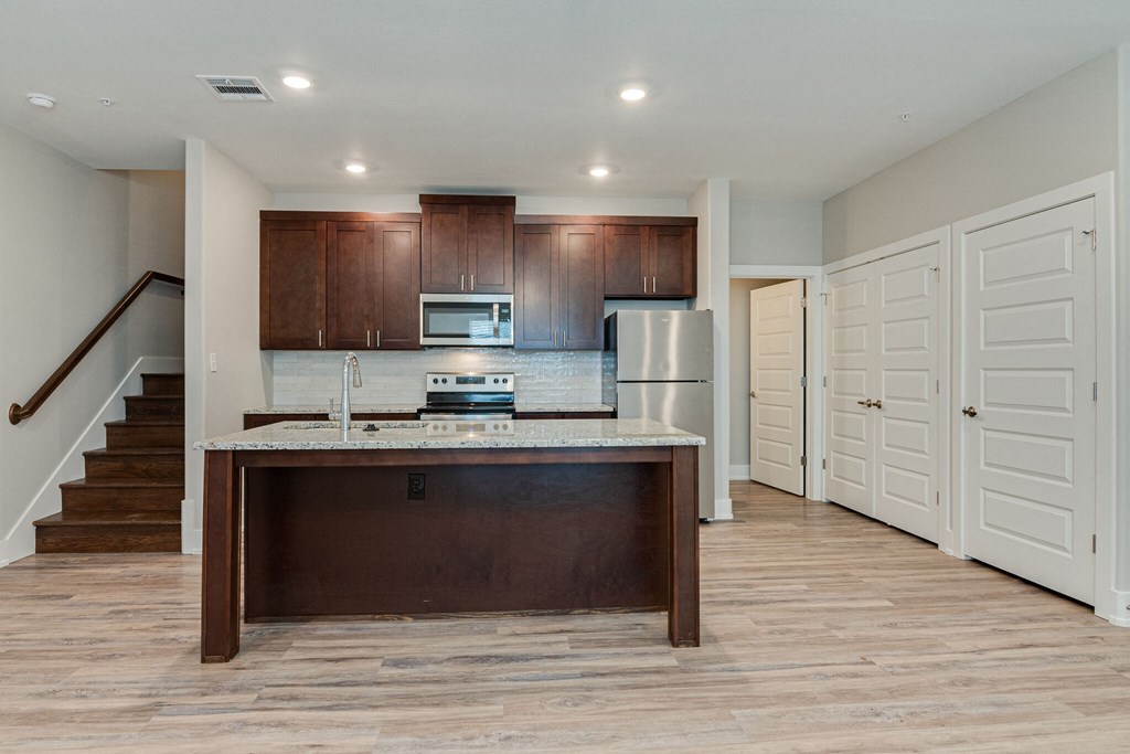 a kitchen with a counter top and a refrigerator
