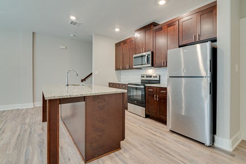 a kitchen with stainless steel appliances and a marble counter top