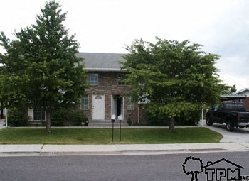 A house with a tree in front of it.
