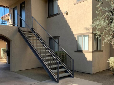 a stairwell with a metal railing on the side of a building