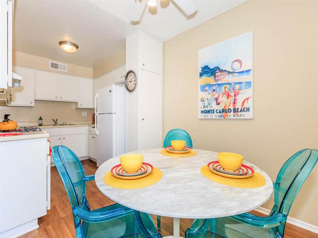 a dining room with a table and chairs and a kitchen