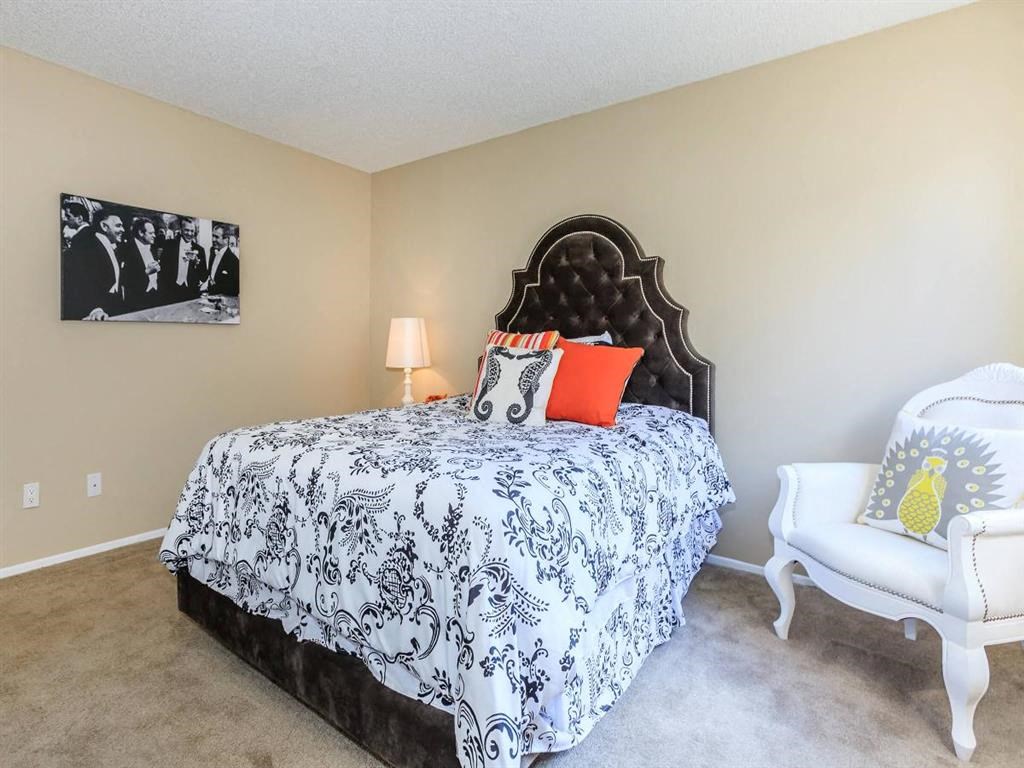 a bedroom with a bed and a chair