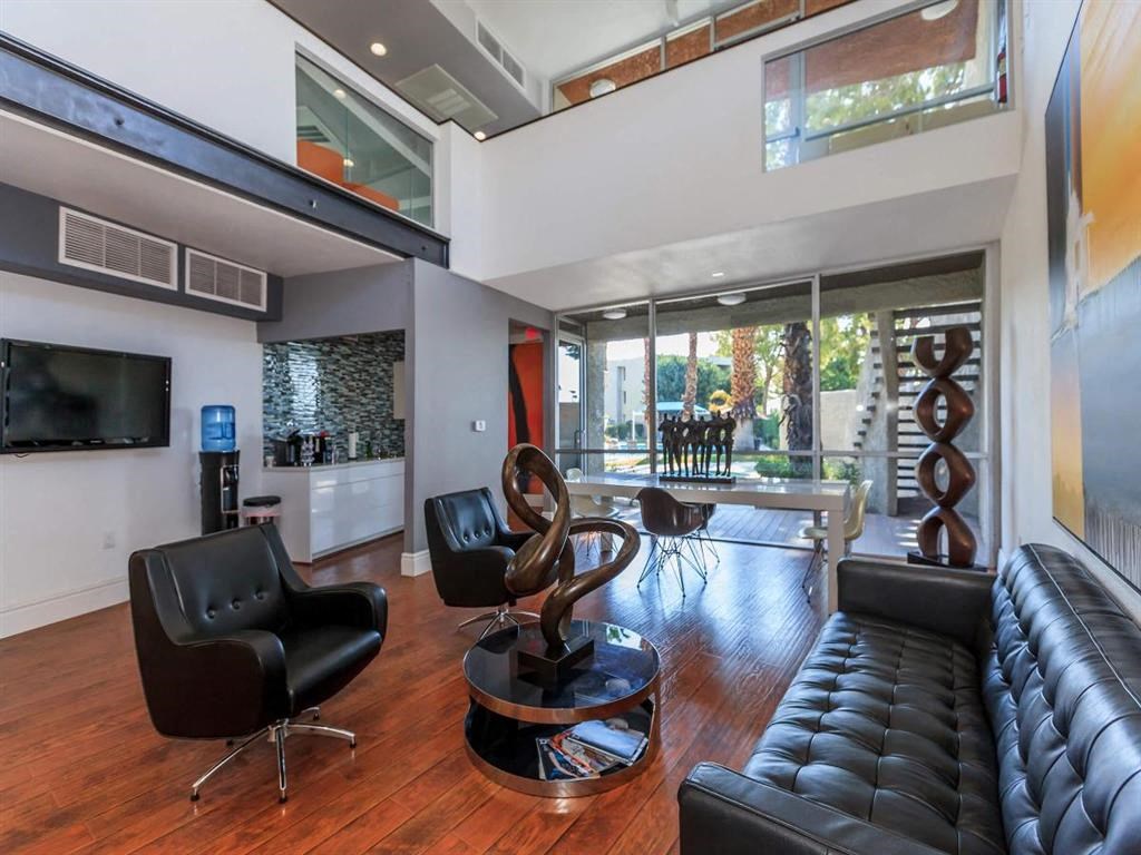 a living room with a leather couch and a tv