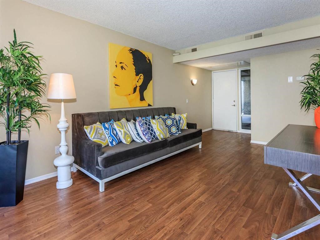 a living room with a couch and a painting on the wall