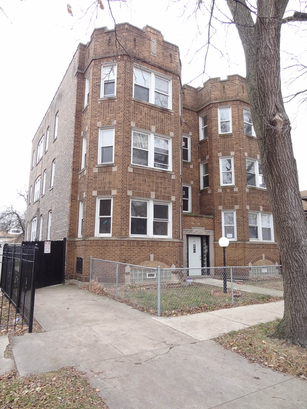 a brick building with a sidewalk in front of it
