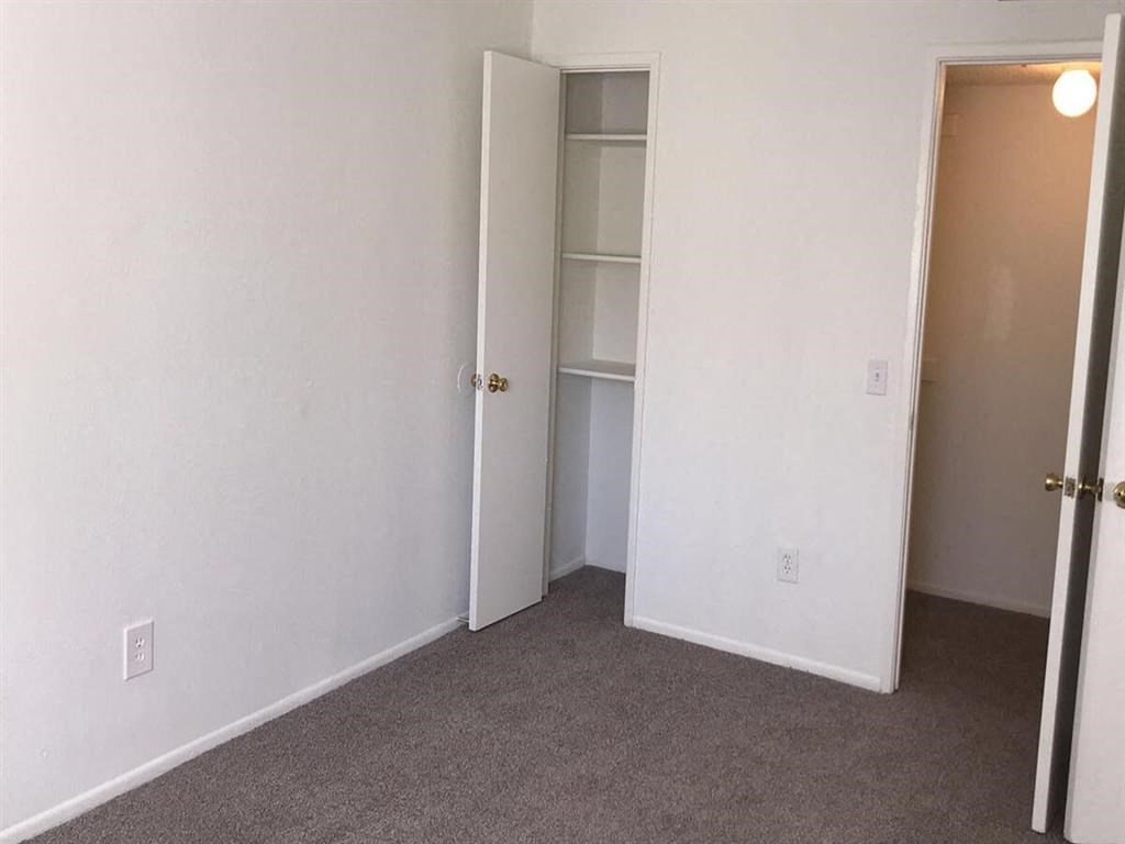 an empty room with a closet and a door