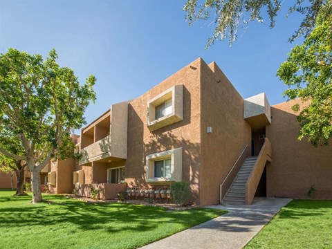 a building with a lawn and trees in front of it