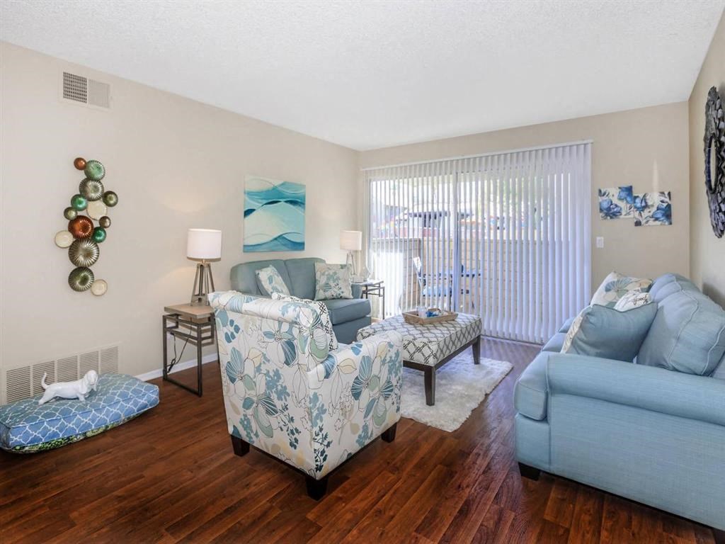 a living room with furniture and a sliding glass door