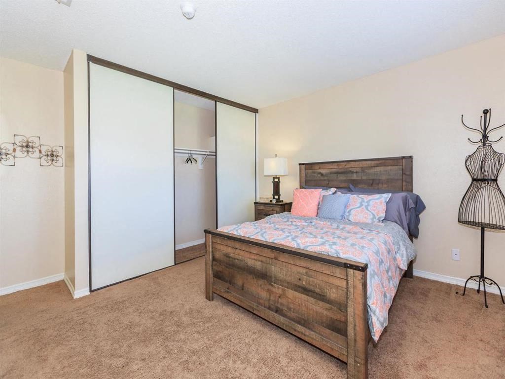 a bedroom with a bed and a closet