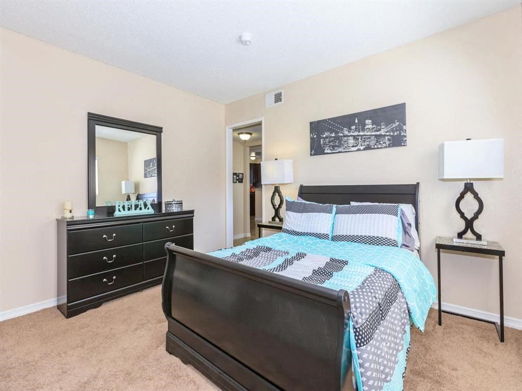 a bedroom with a bed and a mirror