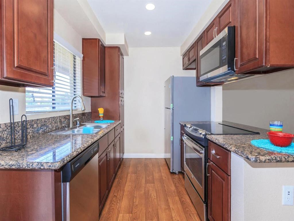 a kitchen with stainless steel appliances and granite counter tops