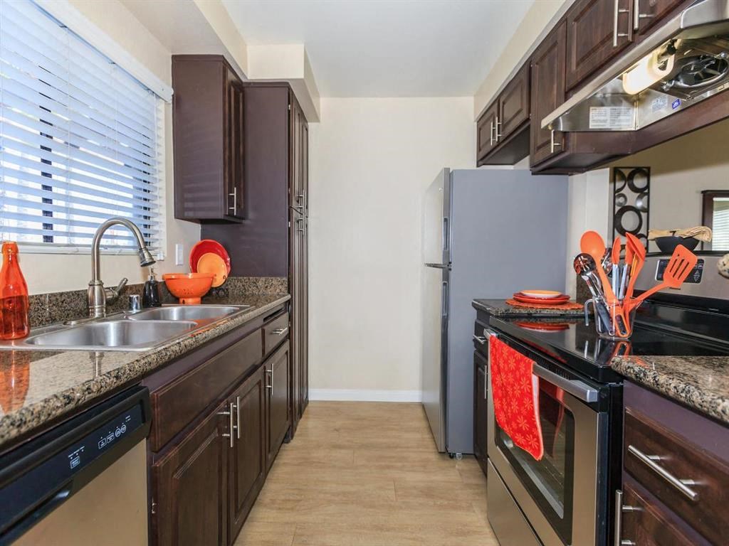 a kitchen with a sink and a refrigerator