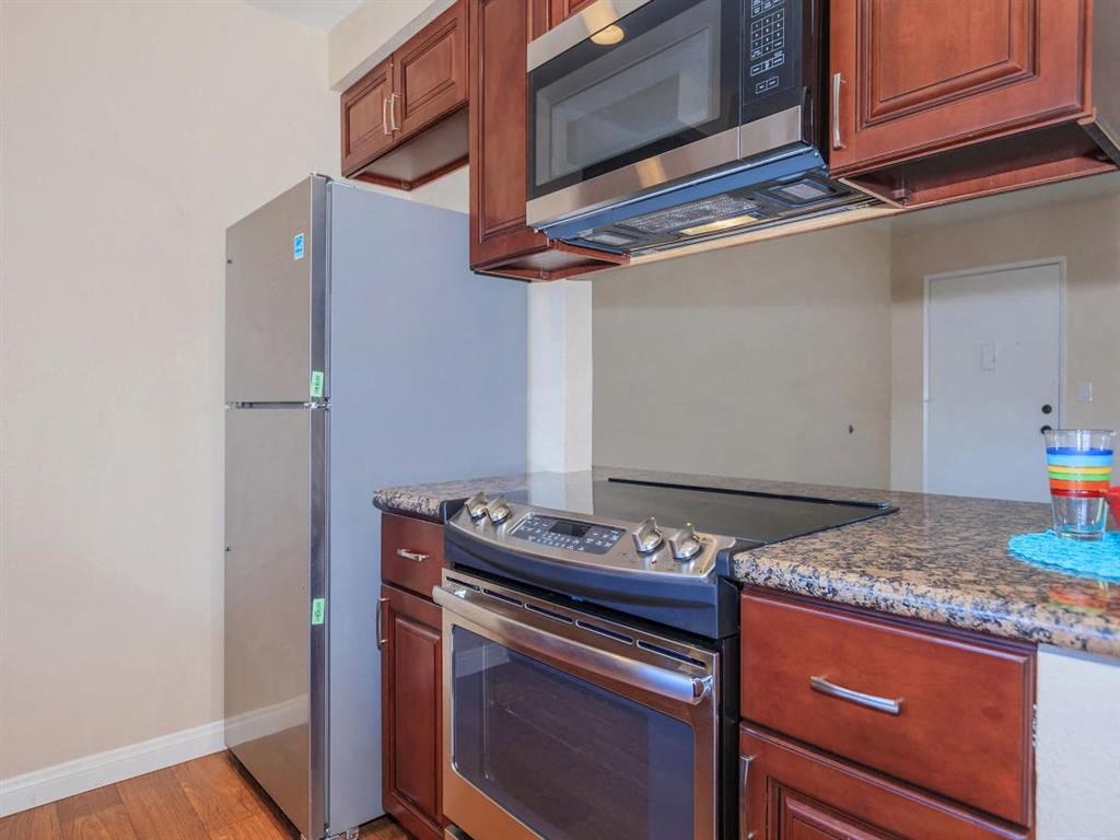 a kitchen with a stove and a refrigerator