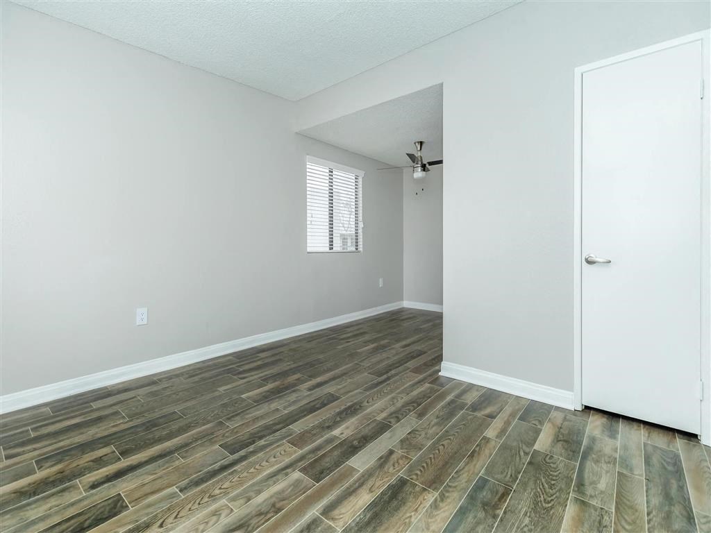 the living room and dining room of a house with wood flooring