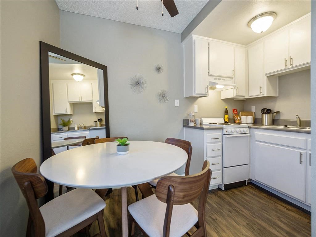 a kitchen with a dining table and a mirror