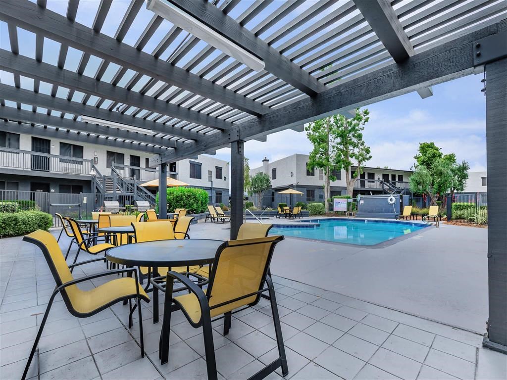 our apartments have a pool and a patio with chairs and tables