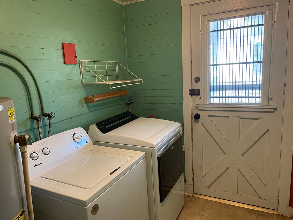 a laundry room with a washer and dryer and a door