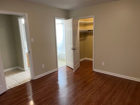 A room with wood flooring and white doors.